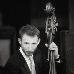 Tom Farmer on bass Tom Farmer on bass in black and white photo