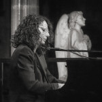 Joanna MacGregor CBE Joanna MacGregor playing piano in black and white photo